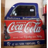 A modern reproduction Coca-Cola advertising car door mirror