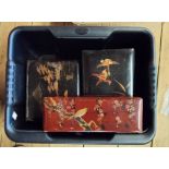 A crate containing four Japanese lacquered boxes and assorted carved wood figurines