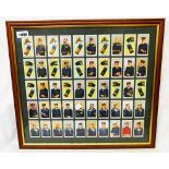 A framed set of Wills' Naval Dress and Badges cigarette cards