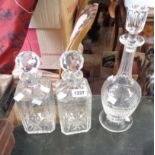 A pair of 20th Century cut crystal square form spirit decanters - sold with another decanter