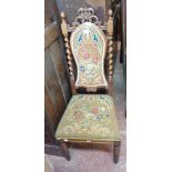 A late Victorian oak framed baronial standard chair with original upholstery and flanking barley