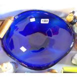 A large free form blue glass dish