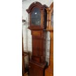 A stained mahogany longcase clock case with spindles to hood and quarter columns to trunk