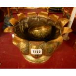 An Indian brass jardiniere of lobed form with chased decoration - sold with two similar bowls