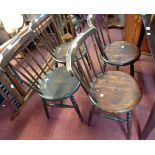 A set of four late 19th Century continental stained wood stick back chairs with circular seat