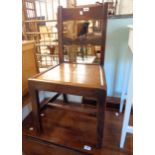 An antique standard chair with decorative splat and elm seat panel, set on chamfered supports