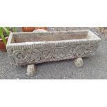 A concrete garden trough planter with armorial decoration and stands