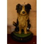 A cast metal and painted doorstop in the form of a seated collie dog