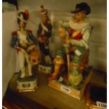 A 20th Century German porcelain figure of a seated soldier drinking wine - sold with two vintage