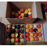 A box containing two boxed sets of pool balls and another loose set