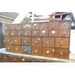 A 1.26m vintage pine and mixed wood apothecary's chest with an array of varying sized drawers with