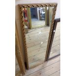 A 20th Century gilt framed narrow oblong wall mirror - small area of border loss