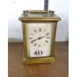 An old brass and bevelled glass cased carriage timepiece with eight day movement - for cleaning