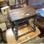 A 45cm oak joint stool in the antique style with shaped apron, set on bobbin turned supports