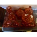 An Art Deco pressed glass dressing table set, comprising candlesticks, tidies and tray