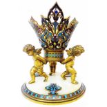 A 19th Century French gilt brass and champleve enamel table centrepiece with three cherubs holding a