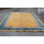 A late 1920's Chinese washed wool carpet with central directional basket of flowers and other floral