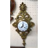 A 19th Century French ornate cast brass cased cartel wall clock with mask and scroll decoration, the