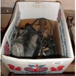 A box containing three vintage telephones