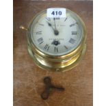 A 12cm diameter vintage brass cased bulkhead timepiece with dial marked for Squire & Sons, Weybridge