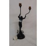 An early 20th Century black painted spelter and brass cherub form twin branch table lamp