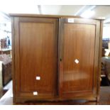 A 61cm Edwardian mahogany and strung cabinet enclosed by a pair of panelled doors - adapted