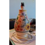 A Poole Pottery table lamp in the Art Deco manner decorated with stylised flowers