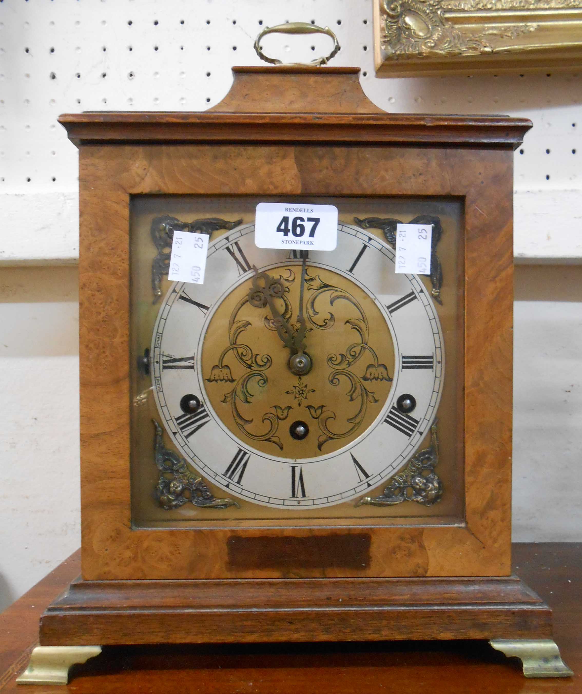 A vintage walnut cased bracket clock with brass and silvered dial and eight day chiming movement