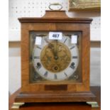 A vintage walnut cased bracket clock with brass and silvered dial and eight day chiming movement