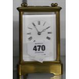 An old brass and bevelled glass cased carriage clock with eight day bell striking movement