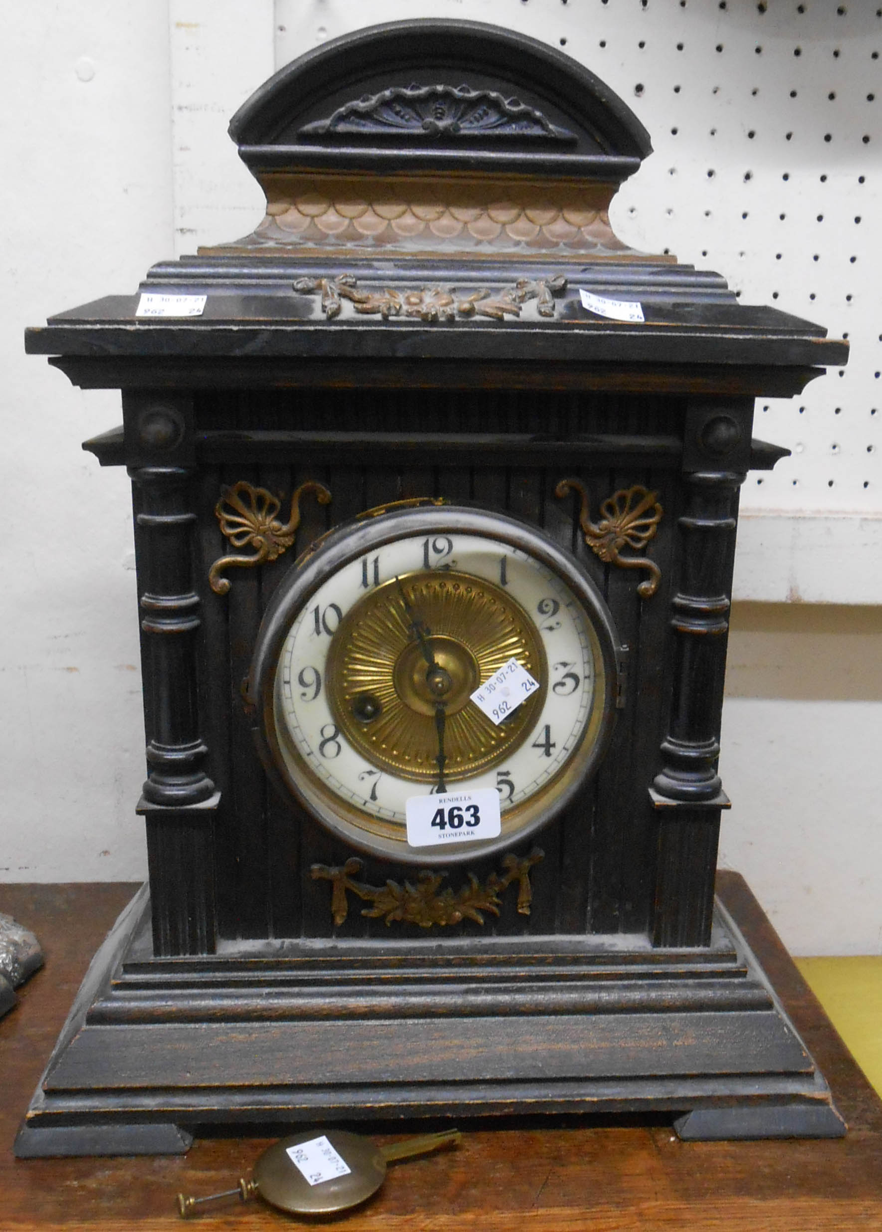 A late 19th Century German stained wood cased mantle clock with scale effect pediment and HAC
