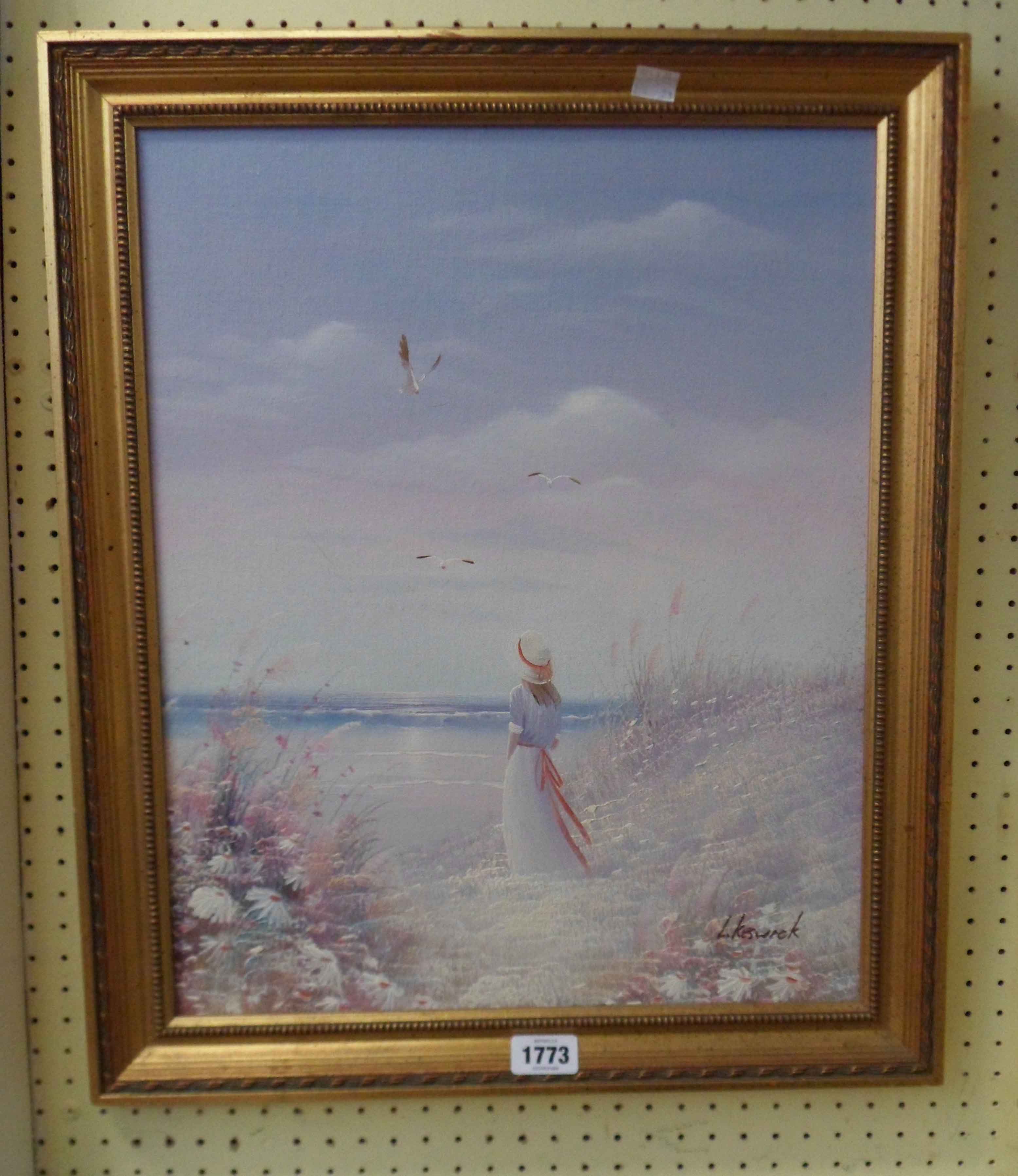 L. Keswick: a gilt framed oil on canvas board, depicting a woman standing on a beach - signed