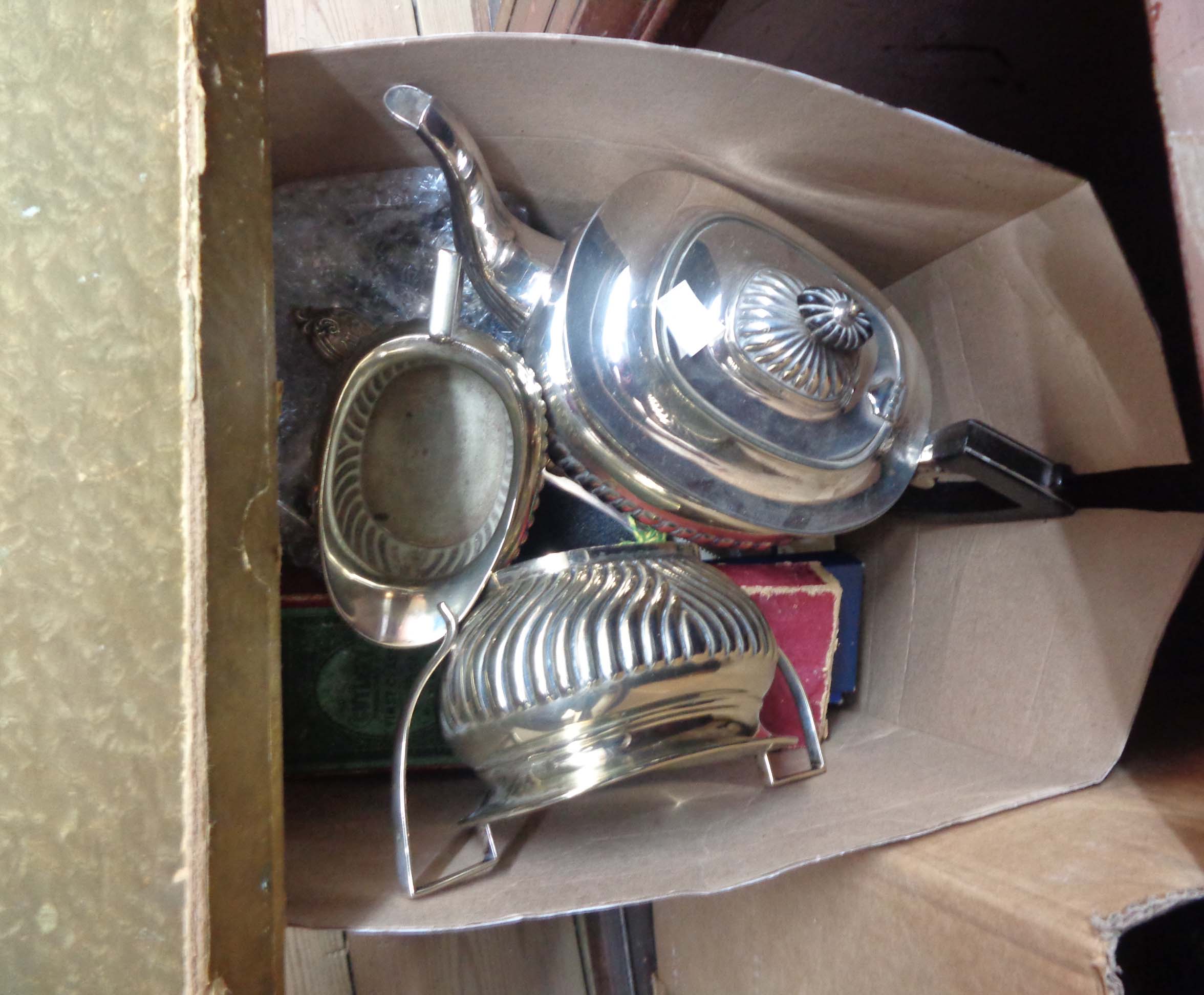 A box containing a quantity of silver plated items including three piece tea set and boxed