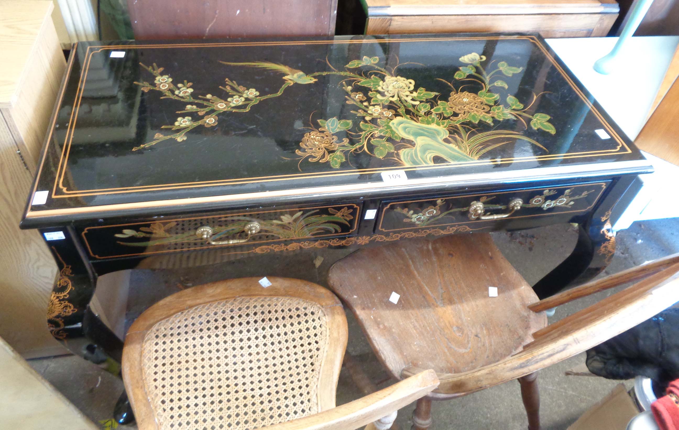 A 102cm late 20th Century chinoiserie style side table with all over decoration on black lacquered