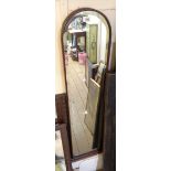 A retro stained wood framed narrow wall mirror with bevelled dome-top plate