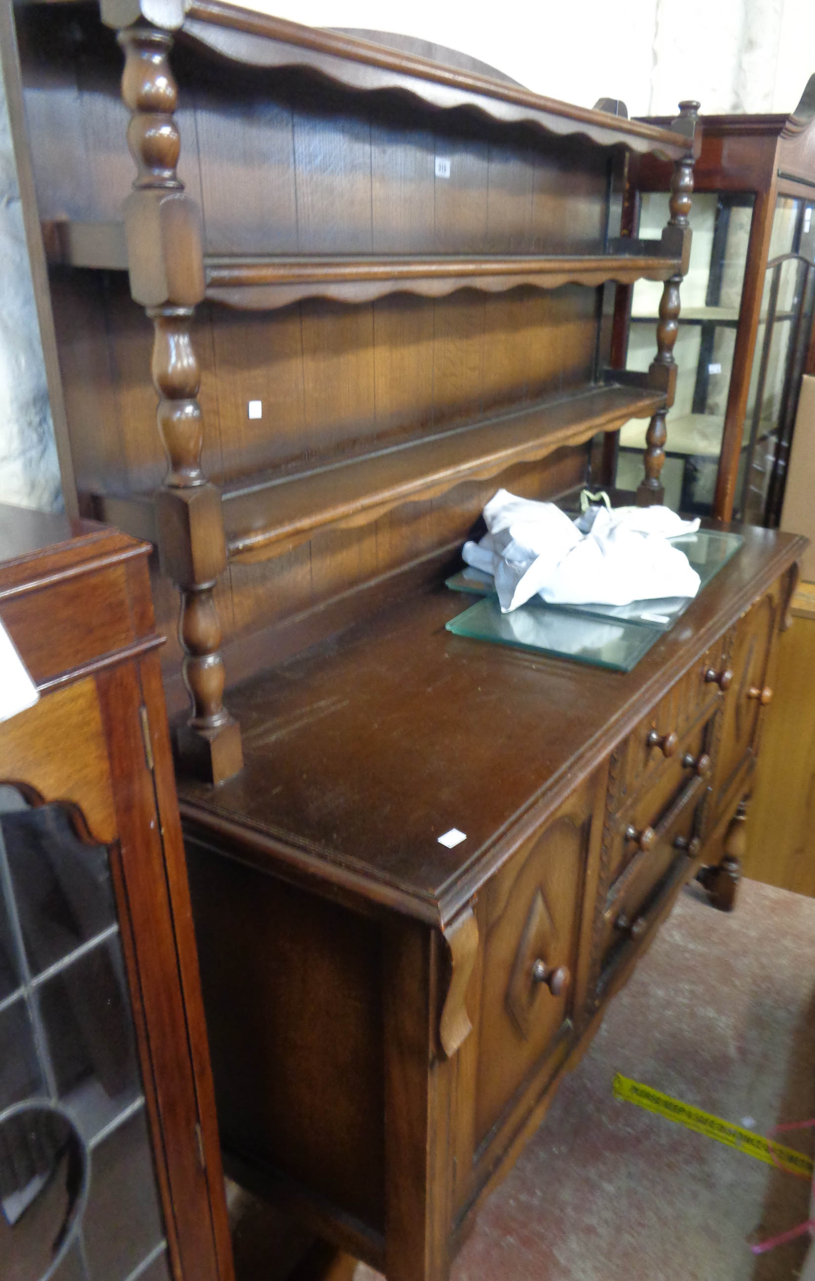 A 1.38m 20th Century Nero polished oak two part dresser with two shelf open plate rack over a base