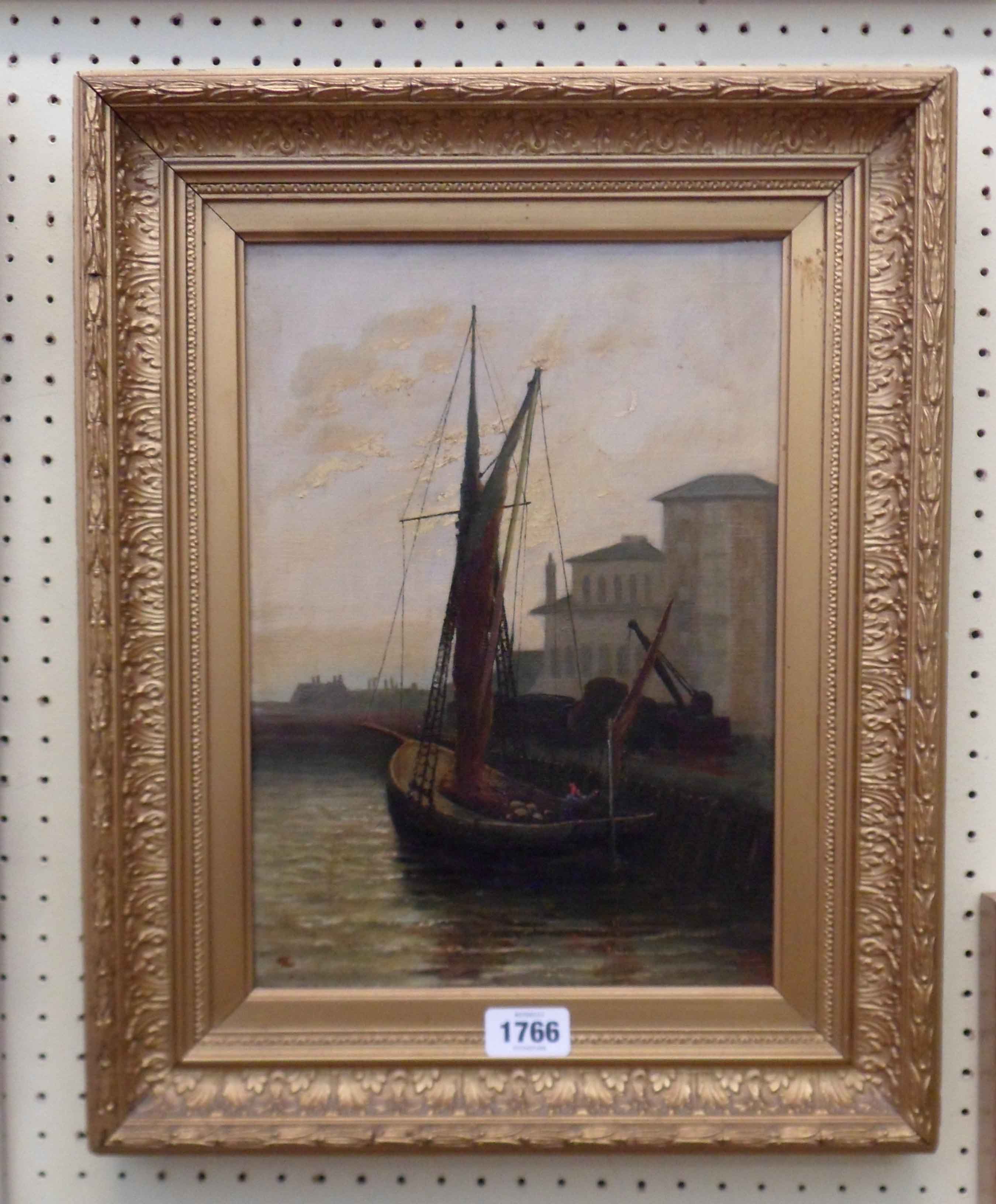 A gilt framed oil on canvas, depicting a fishing vessel in a harbour - signed with monogram,