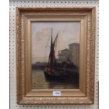 A gilt framed oil on canvas, depicting a fishing vessel in a harbour - signed with monogram,