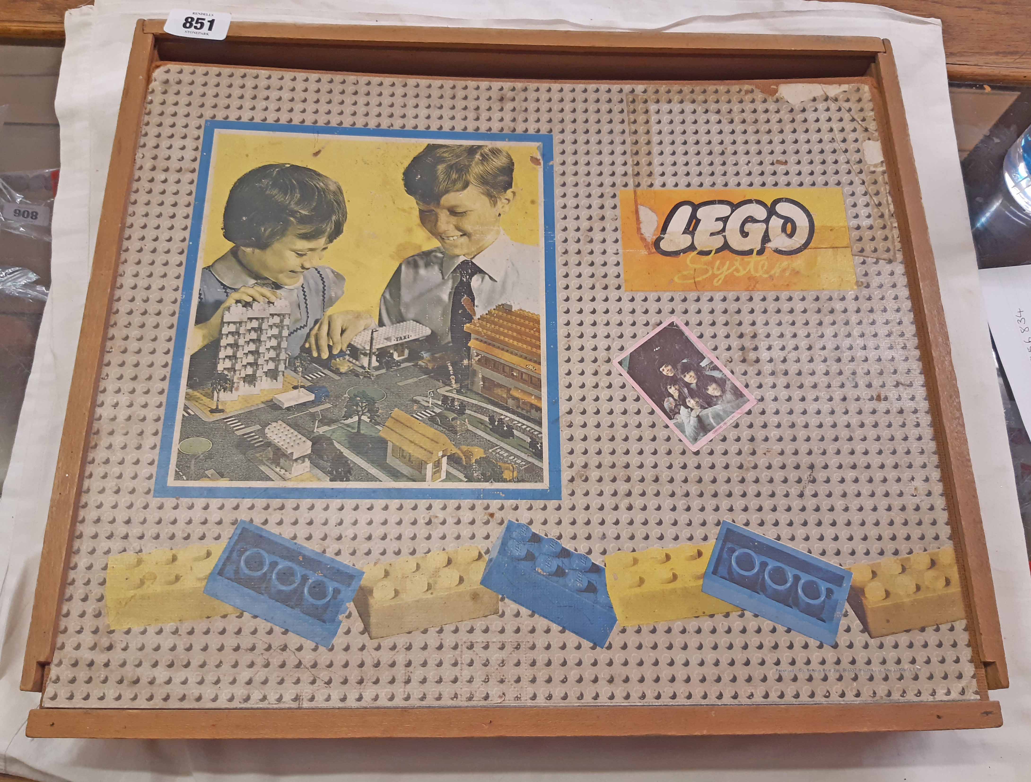 A vintage 1960's Lego system block set in wooden slide top box with quantity of coloured bricks