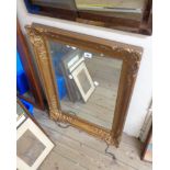 An antique gilt gesso framed oblong wall mirror with later finish