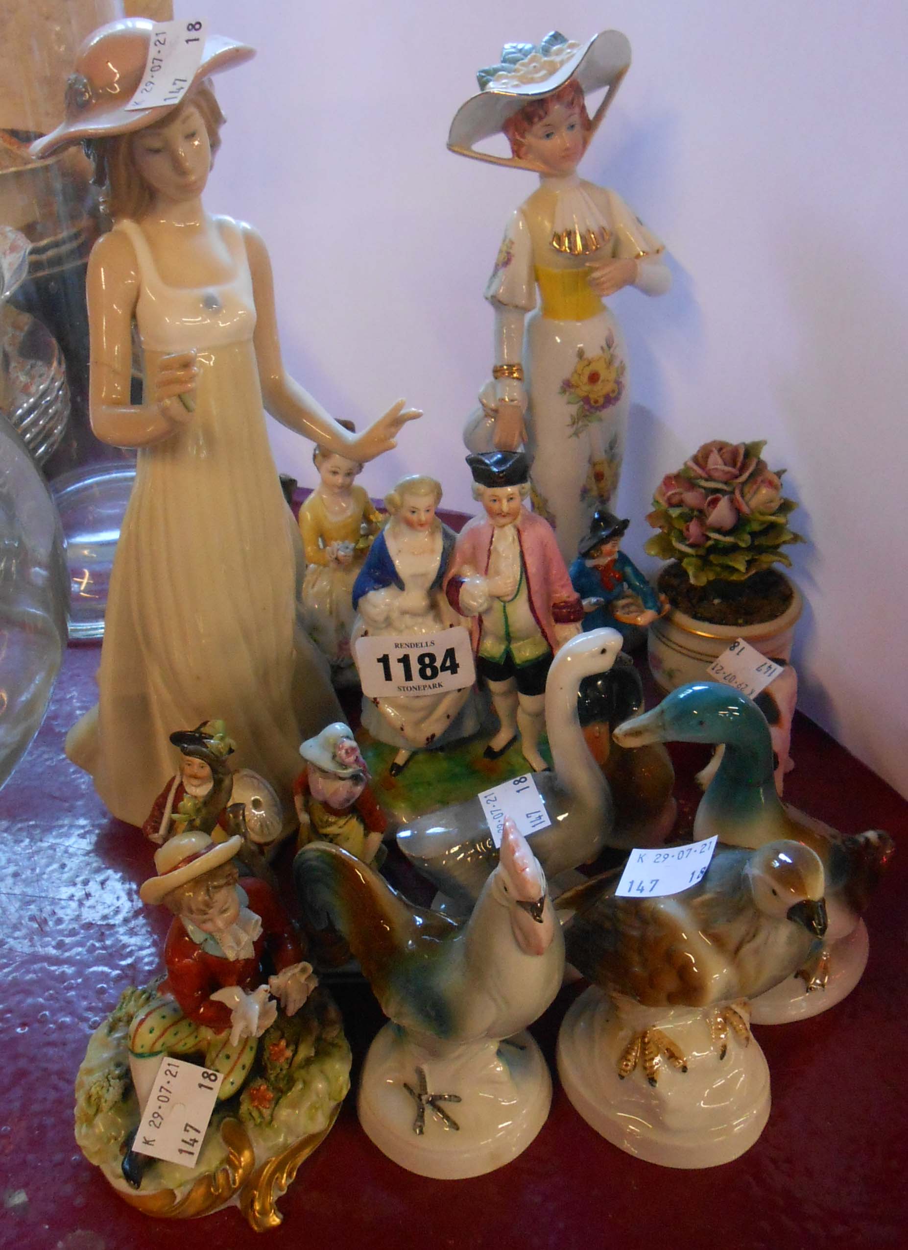 A quantity of assorted ceramic figurines including animals, Capodimonte, Nao, etc.