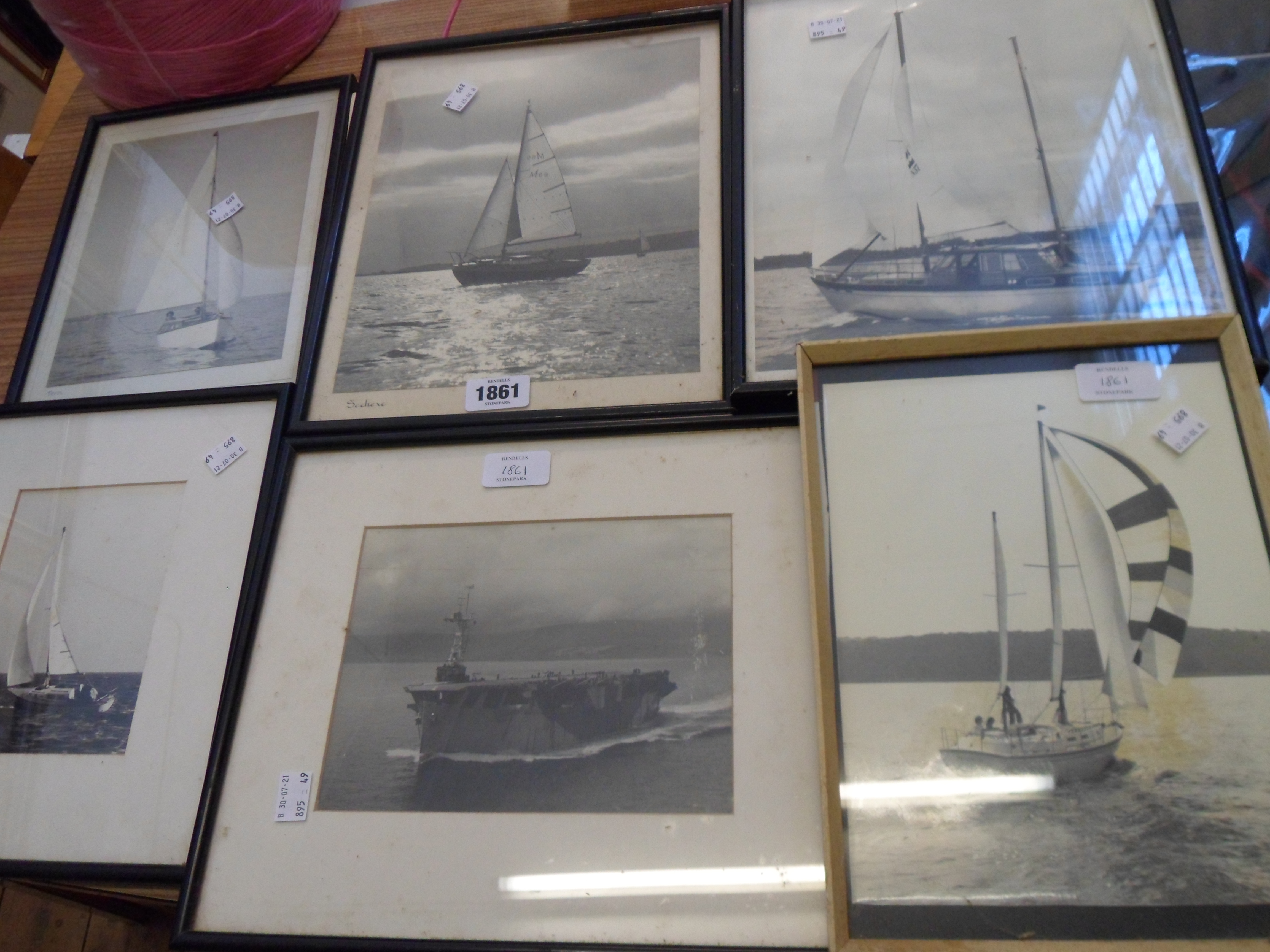 Six framed monochrome photographs of named and other sailing vessels and an aircraft carrier