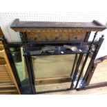 A 100cm late Victorian Aesthetic ebonised overmantel mirror with stork decorated frieze, turned