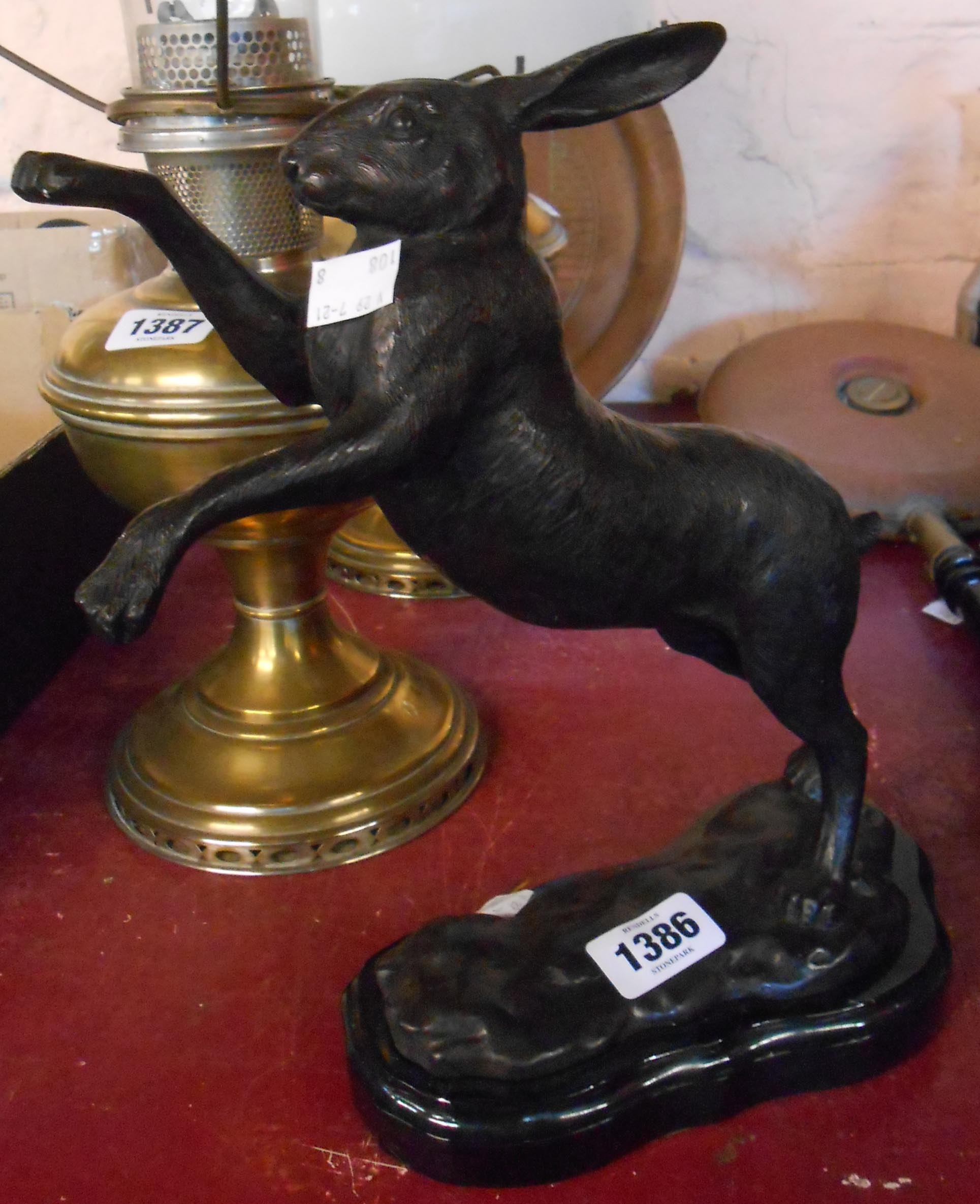 A modern cast bronze model of a boxing hare on a slate plinth