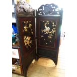 A late 19th Century Oriental ebonised carved wood framed two fold dressing screen with remains of