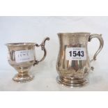 A silver footed cup with ornate cast scroll handle - sold with a small silver baluster tankard -