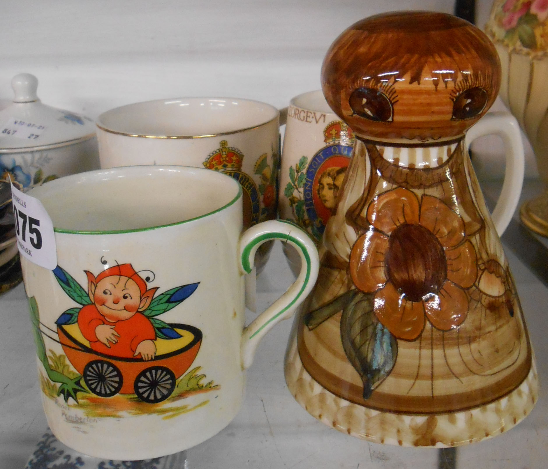 A 1930's child's mug with illustration by Renee Pemberton - sold with a Jersey pottery moneybox