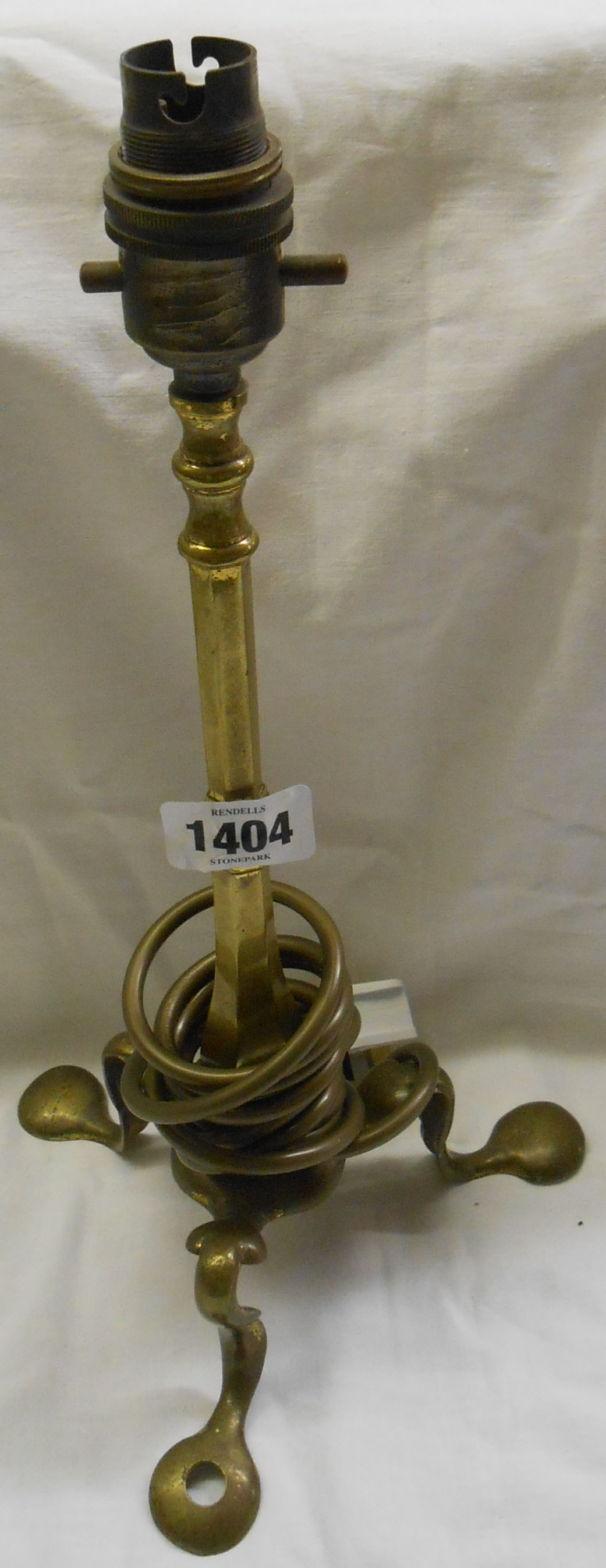 An Edwardian cast brass triple footed table lamp