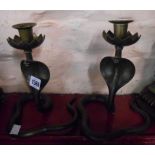A pair of old Indian cast brass cobra candlesticks