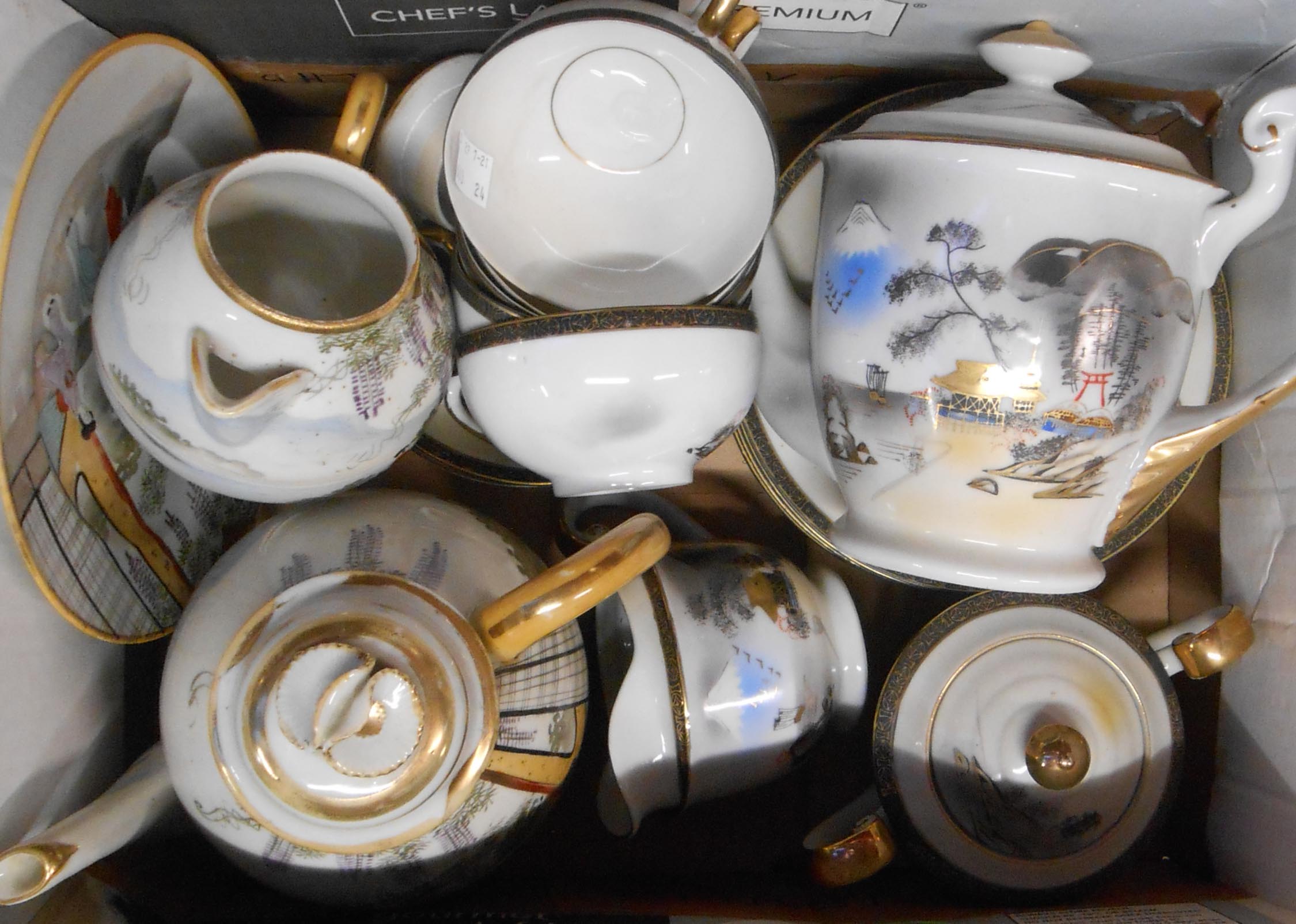 A box containing a selection of Japanese eggshell porcelain china teaware